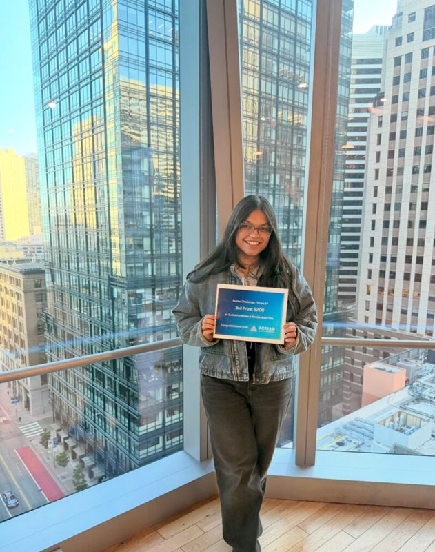 Khushi holding her 3rd place certificate from the Actian track